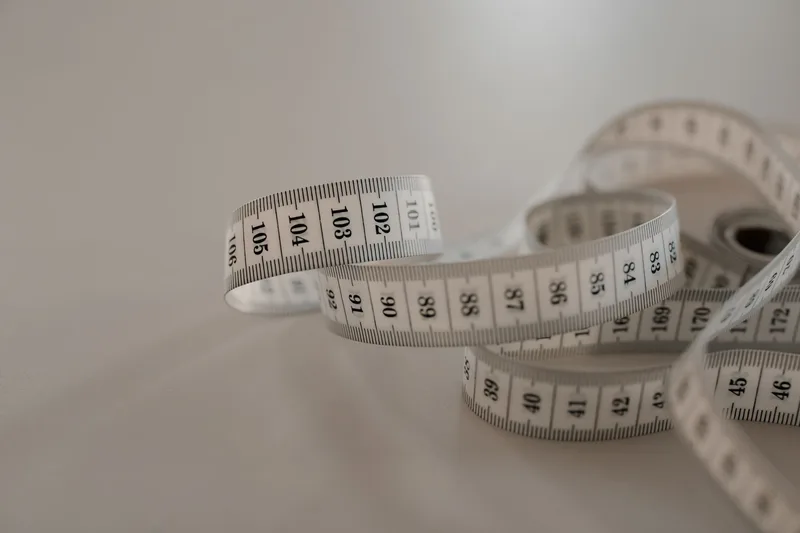 A tape measure marked with centimetre measurements, used to calculate a parcel’s volumetric weight